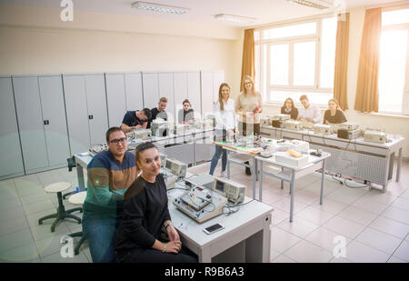 Group of young students doing technical vocational practice with teacher in the electronic classroom, Education and technology concept Stock Photo