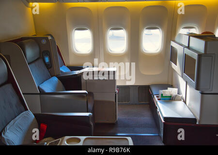 Plane interiors of the first class luxury business seats with bar and ...