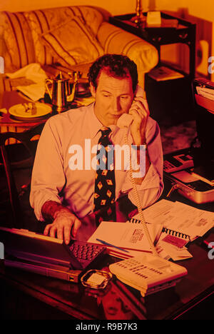 Salesman or business man working in a hotel room, a on the road warrior Stock Photo