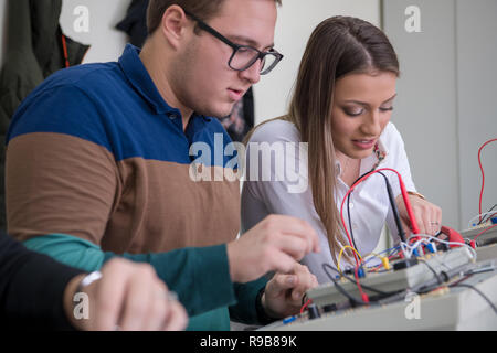 Group of young students doing technical vocational practice with teacher in the electronic classroom, Education and technology concept Stock Photo