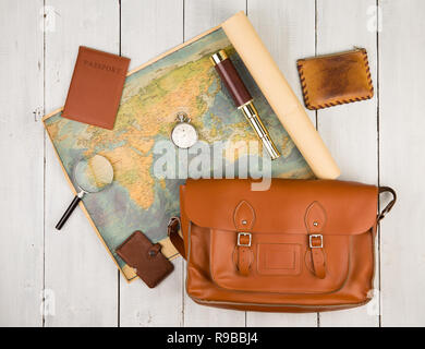 Travel concept - geographic map, passport, bag, magnifying glass, purse, spyglass and stopwatch on white wooden table Stock Photo