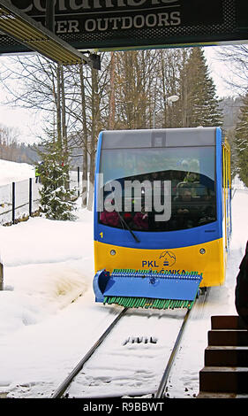 ZAKOPANE, POLAND - DECEMBER 31, 2010: The cable car rides from the peak of Gubalowka (1126 m n.p.m.). The funicular was built in 1938 Stock Photo