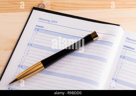 Business concept - Top view of an open notebook diary in hardcover with the word 2019, record of wishes and plans for 2019 Stock Photo