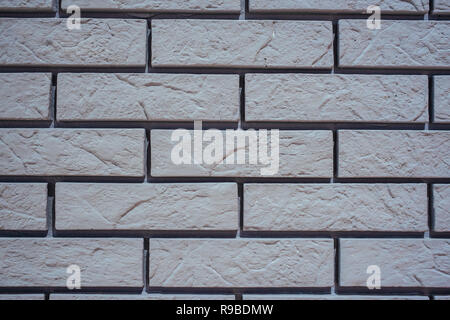 Tiled old painted white brick wall background in Kyiv, Ukraine Stock Photo