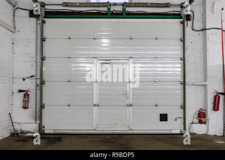 White rolling shutter at warehouse interior Stock Photo