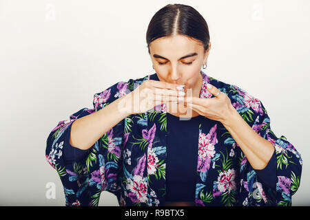 Beautiful girl drinking a tea in a studio Stock Photo