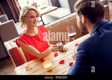 Young man and woman on date in restaurant sitting at table Stock Photo