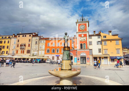 Main square of historic town centre with fountain and old statue of boy holding fish. Rovinj, Croatia Stock Photo