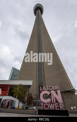 TORONTO, CANADA - NOVEMBER 13, 2018: View of the Canadian National Tower (CN Tower)  from its bottom with its iconic logo and the entrance. It is one 