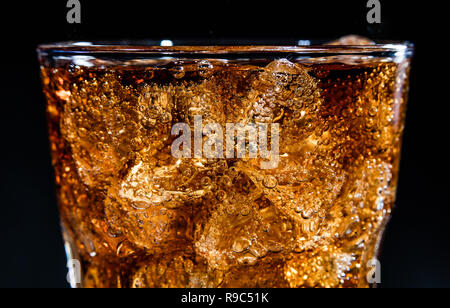 Glass with soft cola drink, ice and bubles Stock Photo