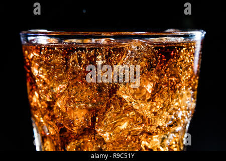 Glass with soft cola drink, ice and bubles Stock Photo