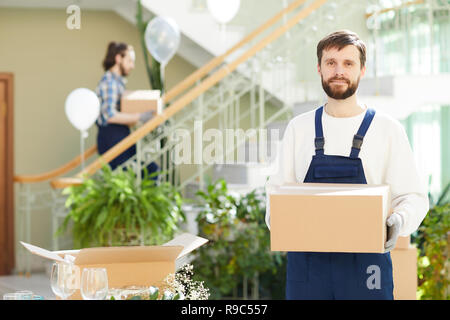Content bearded mover delivering boxes Stock Photo
