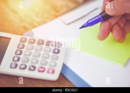 calculator and pen finance object business accounting concept / financial data analyzing hand calculator and notes paper on old wooden background Stock Photo