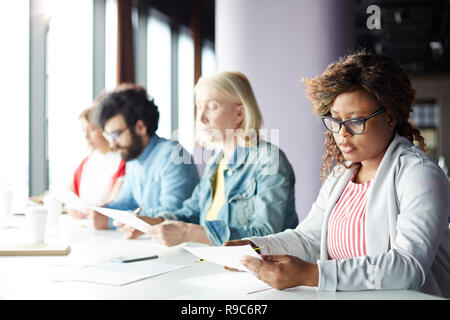 Co-workers reading Stock Photo