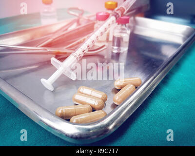 Equipment medical instruments / Syringe injection needle medical drug in steel tray for nurse or doctor surgical -  plastic medical syringe and Capsul Stock Photo