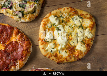 Gourmet Homemade Assorted Wood Fired Pizzas with Pepperoni Basil and Cheese Stock Photo