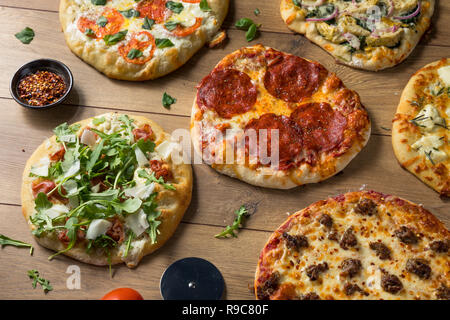 Gourmet Homemade Assorted Wood Fired Pizzas with Pepperoni Basil and Cheese Stock Photo