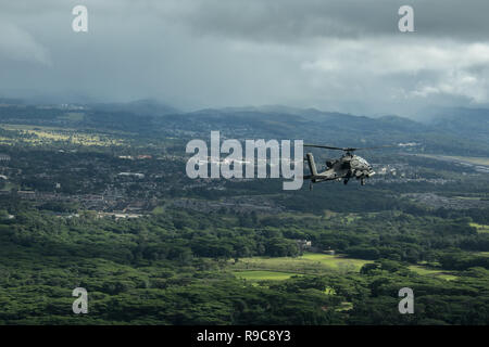 U.S. Army AH-64D Apache helicopter, assigned to the 25th Infantry Division, flies in formation for the 25th Infantry Division Review over Schofield Barracks, Hawaii, December 21, 2018. The Division’s activation date is October 1, 1941. Due to a robust training schedule in October, the Division is celebrating its birthday from December 17-21 with the culminating event being the Division Review at historic Weyand Field. More than 11,000 Tropic Lightning Soldiers will take part in the Division Review. (U.S. Army photo by Staff Sgt. Ian Morales) Stock Photo