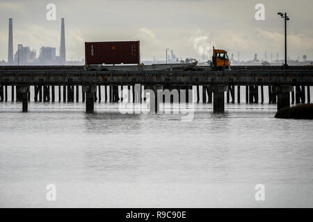 A U.S. Army Reserve Soldier transports a Twenty-foot equivalent unit container across a pier to a staging area during Operation Trans Mariner at Military Ocean Terminal Concord, California, Mar. 2, 2018. Trans Mariner 18 West is a real-world strategic mission utilizing U.S. Army Reserve and Active component Soldiers to conduct Port Operations allowing Army materiel and munitions containers for travel onward.    (U.S. Army photo by Sgt. Eben Boothby) Stock Photo