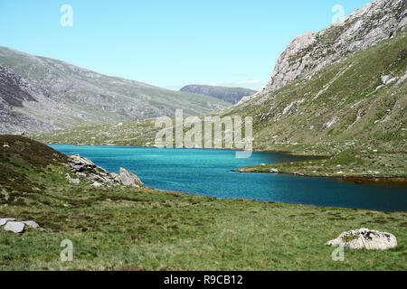 Cwm Idwal is a cirque (or corrie) in the Glyderau Range of the Snowdonia National Park. Here the green water of lake (Llyn Idwal) has been enhanced. Stock Photo