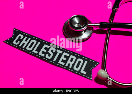 Cholesterol on the paper with healthcare Concept. With stethoscope on pink bakcground Stock Photo