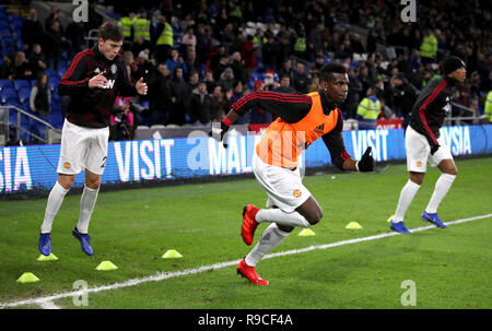 Manchester United's Paul Pogba (centre) warms up prior to the Premier League match at the Cardiff City Stadium. PRESS ASSOCIATION Photo. Picture date: Saturday December 22, 2018. See PA story SOCCER Cardiff. Photo credit should read: Nick Potts/PA Wire. RESTRICTIONS: No use with unauthorised audio, video, data, fixture lists, club/league logos or 'live' services. Online in-match use limited to 120 images, no video emulation. No use in betting, games or single club/league/player publications. Stock Photo