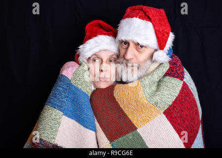 Portrait of an adult man with white beard and a woman disguised in Santa Claus for the Christmas Holiday Stock Photo