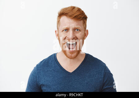 Young Redhead Man Over Grey Grunge Wall With Hand On Chin Thinking 