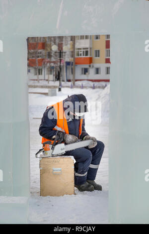 A manual file worker sharpens a chainsaw chain Stock Photo