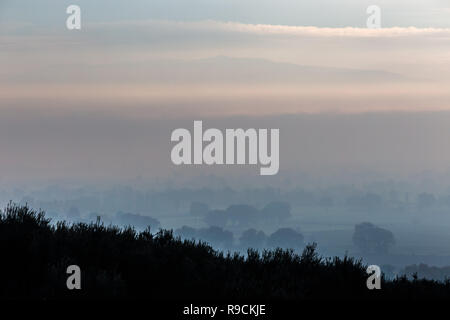 Moody view of Umbria valley (Italy) in the midst of autumn mist