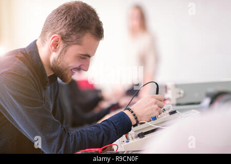 Group of young students doing technical vocational practice with teacher in the electronic classroom, Education and technology concept Stock Photo
