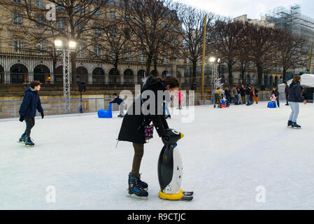 Ice rink in Christmas market in Tuileries Gardens, Paris, France Stock Photo