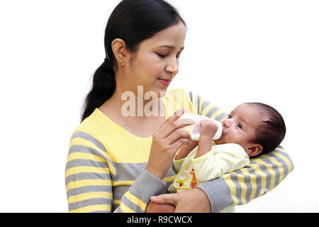 Mother feeding milk to newborn baby Stock Photo