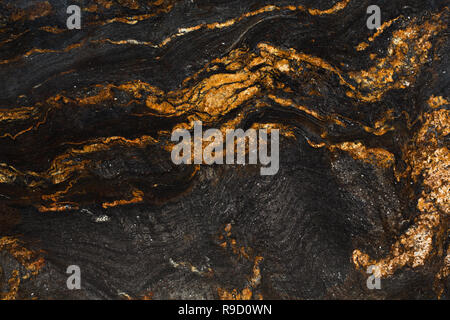 Natural slate with shades of gold and black. Stock Photo