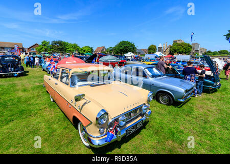 1950's vintage car, Ford Consul in field with other cars arranged in lines as part of a classic car show at Ramsgate, England. People, blue sky. Stock Photo