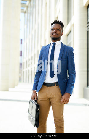 Pensive black entrepreneur with briefcase Stock Photo