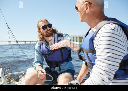 Bearded man explaining sailing rules Stock Photo