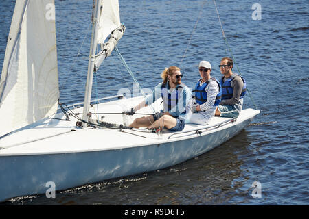 Men sitting on yacht deck Stock Photo