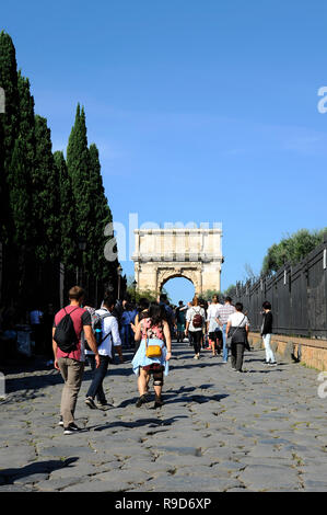 ROME - October 09, 2018: People entering the Roman Forum through the Via Sacra. Arch of Titus in the opposite end. Stock Photo
