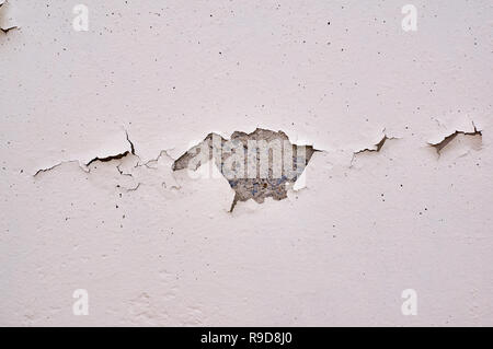Painted beige wall with cracks and chipped. Stock Photo