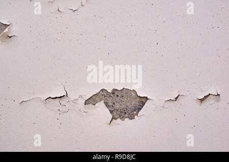 Painted beige wall with cracks and chipped. Stock Photo