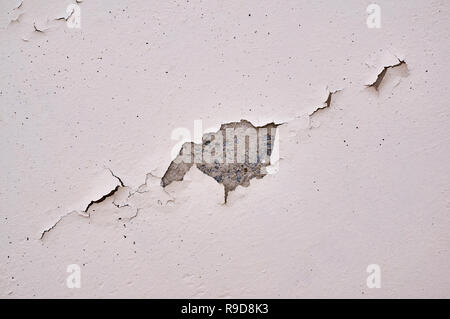 Painted beige wall with cracks and chipped. Stock Photo