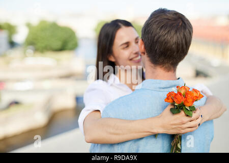 Small bouquet of roses in hands of girlfriend Stock Photo