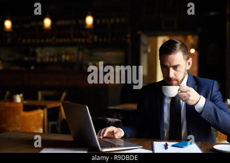 Thoughtful businessman working on report Stock Photo