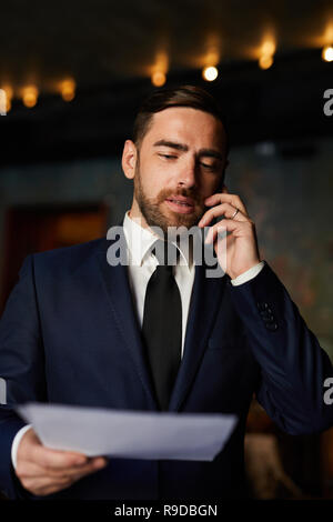 Successful manager explaining contract content on phone Stock Photo