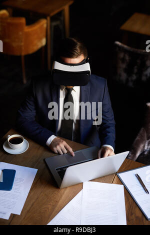 Modern businessman using VR headset Stock Photo
