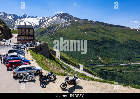 Motorcycles and cars parked at Hotel Belvedere on the road to Furka Pass, near Rhone Glacier. Valais, Switzerland, July 2018 Stock Photo