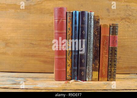 Books on wooden background. Old vintage books on wooden brown background. Copy space. Concept of the reading, education and still life Stock Photo