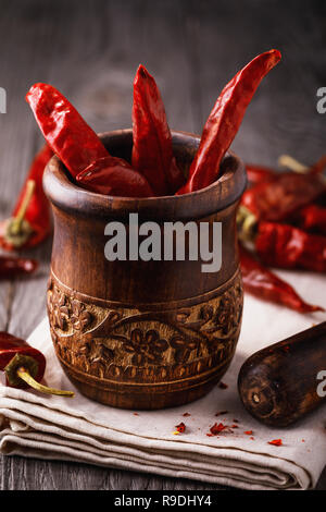 Dried peppers and kitchen chopper on a wooden table, closeup Stock Photo