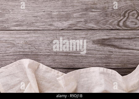 Top view of a gray tablecloth at the bottom of a wooden table. Food background Stock Photo